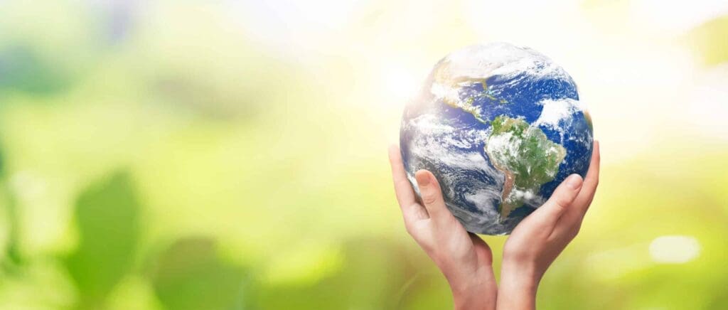 two hands holding up the globe celebrating world environment day